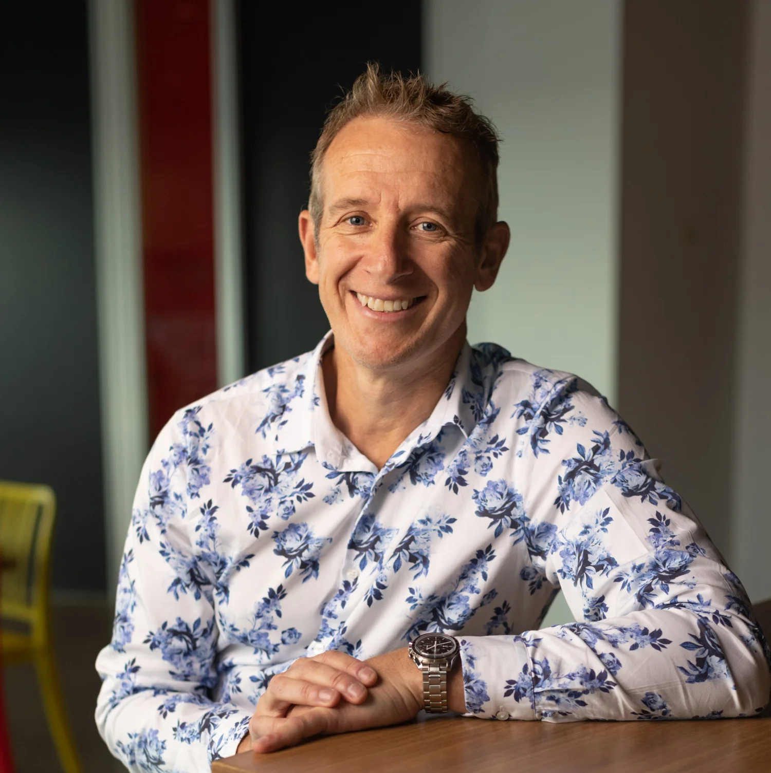 Alan Baird smiling, seated at a table